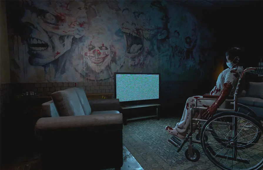un macabé sur un fauteuil roulant devant une télévision